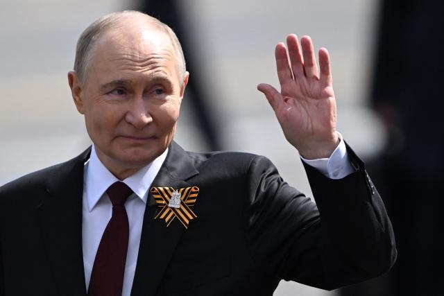 Russia's President Vladimir Putin waves as he leaves Red Square after the Victory Day military parade in central Moscow on May 9, 2025. Russia celebrates the 80th anniversary of the Soviet Union's victory over Nazi Germany in World War Two (WWII). (Photo by Kirill KUDRYAVTSEV / AFP)