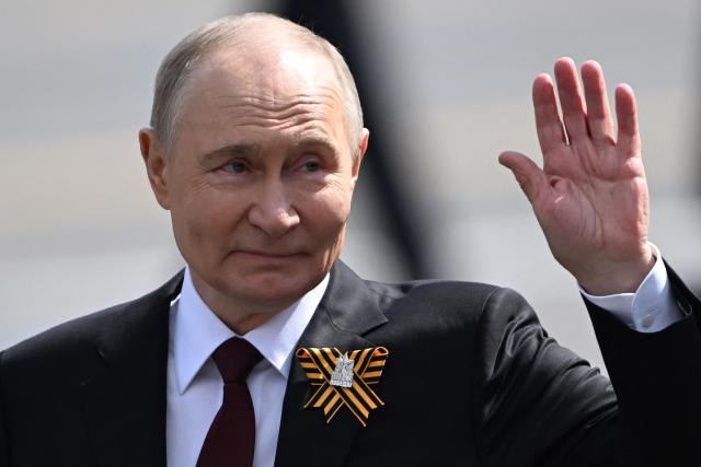 Russia's President Vladimir Putin waves as he leaves Red Square after the Victory Day military parade in central Moscow on May 9, 2025. Russia celebrates the 80th anniversary of the Soviet Union's victory over Nazi Germany in World War Two (WWII). (Photo by Kirill KUDRYAVTSEV / AFP)