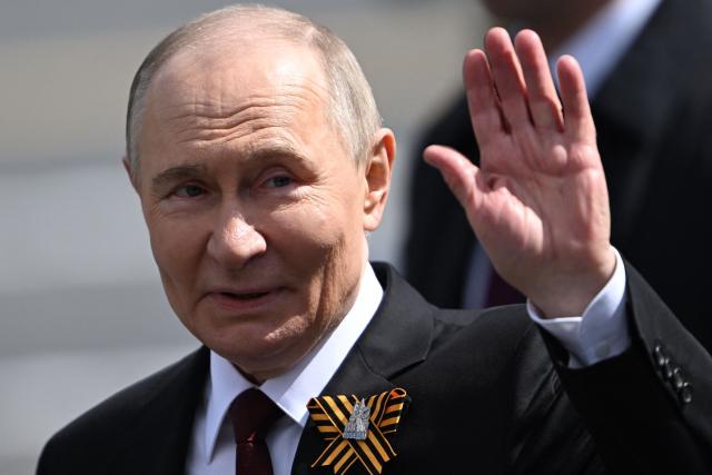 Russia's President Vladimir Putin waves as he leaves Red Square after the Victory Day military parade in central Moscow on May 9, 2025. Russia celebrates the 80th anniversary of the Soviet Union's victory over Nazi Germany in World War Two (WWII). (Photo by Kirill KUDRYAVTSEV / AFP)