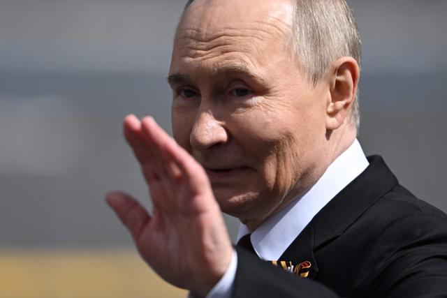 Russia's President Vladimir Putin waves as he leaves Red Square after the Victory Day military parade in central Moscow on May 9, 2025. Russia celebrates the 80th anniversary of the Soviet Union's victory over Nazi Germany in World War Two (WWII). (Photo by Kirill KUDRYAVTSEV / AFP)