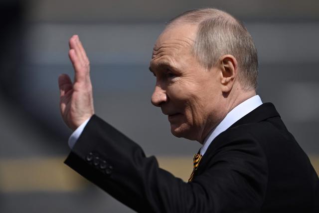 Russia's President Vladimir Putin waves as he leaves Red Square after the Victory Day military parade in central Moscow on May 9, 2025. Russia celebrates the 80th anniversary of the Soviet Union's victory over Nazi Germany in World War Two (WWII). (Photo by Kirill KUDRYAVTSEV / AFP)