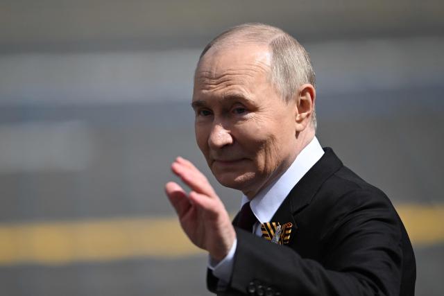 Russia's President Vladimir Putin waves as he leaves Red Square after the Victory Day military parade in central Moscow on May 9, 2025. Russia celebrates the 80th anniversary of the Soviet Union's victory over Nazi Germany in World War Two (WWII). (Photo by Kirill KUDRYAVTSEV / AFP)