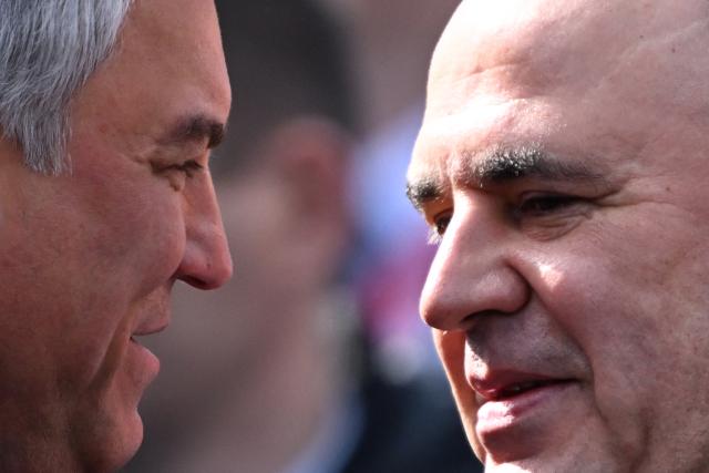 Russia's State Duma Speaker Vyacheslav Volodin (L) speaks with Russia's Prime Minister Mikhail Mishustin (R) during the Victory Day military parade at Red Square in central Moscow on May 9, 2025. Russia celebrates the 80th anniversary of the Soviet Union's victory over Nazi Germany in World War Two (WWII). (Photo by Kirill KUDRYAVTSEV / AFP)