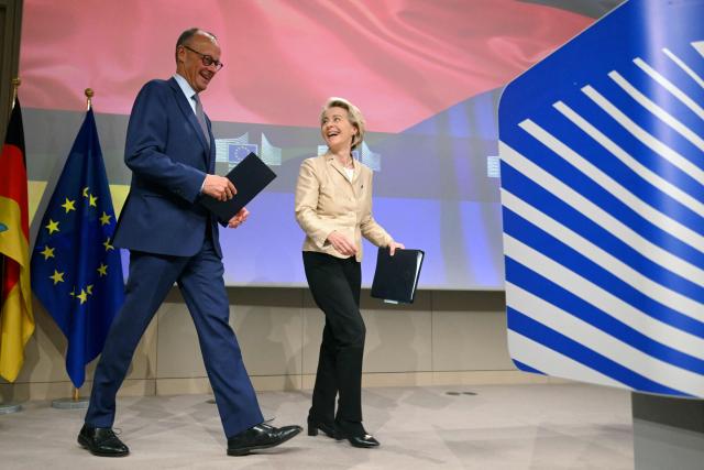 European Commission President Ursula Von der Leyen (R) and German Chancellor Friedrich Merz (L) arrive to give a joint press conference at the EU headquarters in Brussels on May 9, 2025. (Photo by Nicolas TUCAT / AFP)