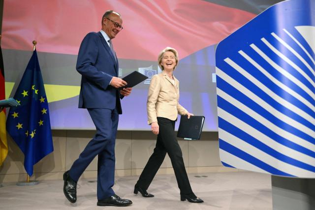 European Commission President Ursula Von der Leyen (R) and German Chancellor Friedrich Merz (L) arrive to give a joint press conference at the EU headquarters in Brussels on May 9, 2025. (Photo by Nicolas TUCAT / AFP)