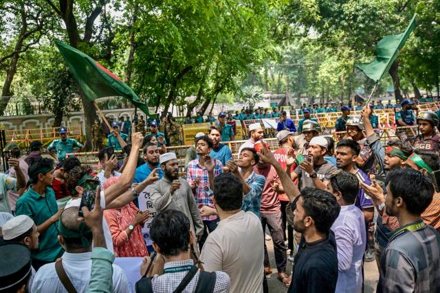 Protesters gather in front of the State Guest House Jamuna, the official residence of Bangladesh's Chief Advisor Office of Interim Government Muhammad Yunus, demanding a ban on the ousted Sheikh Hasina’s party, the Awami League, in Dhaka on May 9, 2025. (Photo by Munir UZ ZAMAN / AFP)