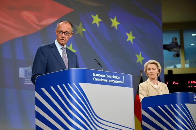 European Commission President Ursula Von der Leyen (R) and German Chancellor Friedrich Merz (L) give a joint press conference at the EU headquarters in Brussels on May 9, 2025. (Photo by Nicolas TUCAT / AFP)