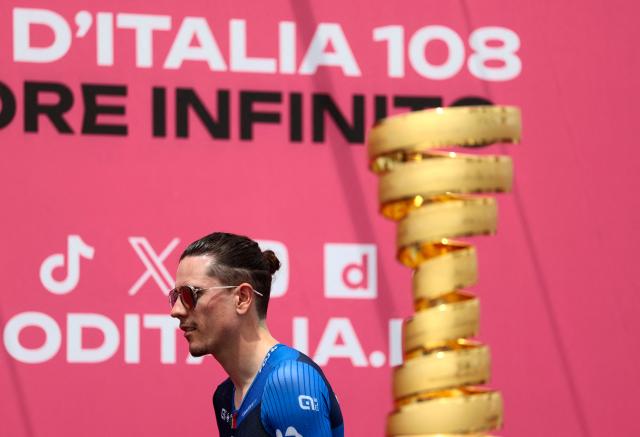 Groupama-FDJ's French rider David Gaudu walks past the Giro d'Italia trophy (“trofeo senza fine”) prior to the first stage of the 108th Giro d'Italia cycling race, 160km from Durres to Tirana in Albania, on May 9, 2025. (Photo by Luca Bettini / AFP)