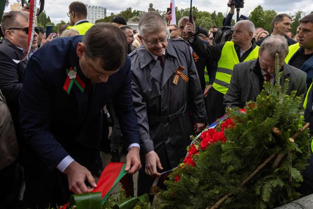 Russia's Ambassador to Poland Sergey Andreev (C) lays a wreath at the Soviet soldier mausoleum in Warsaw, Poland on May 9, 2025. (Photo by Wojtek RADWANSKI / AFP)