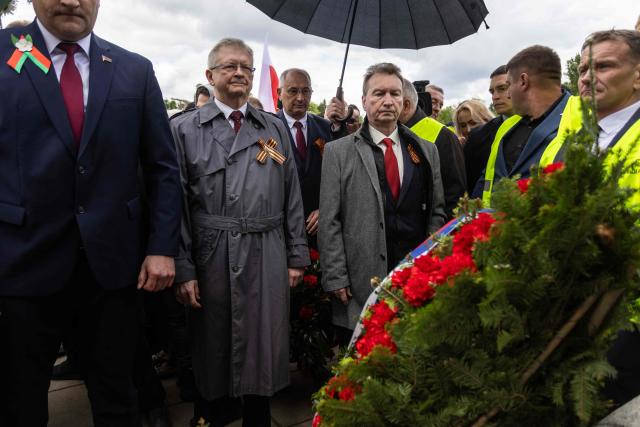 Russia's Ambassador to Poland Sergey Andreev (C) observes a moment of silence after he laid a wreath at the Soviet soldier mausoleum in Warsaw, Poland on May 9, 2025. (Photo by Wojtek RADWANSKI / AFP)