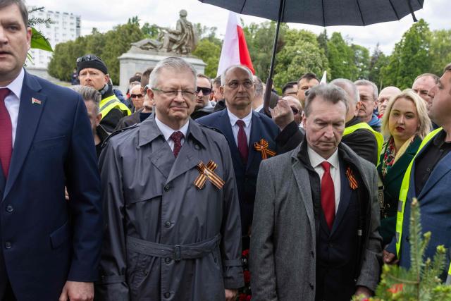 Russia's Ambassador to Poland Sergey Andreev (C) observes a moment of silence after he laid a wreath at the Soviet soldier mausoleum in Warsaw, Poland on May 9, 2025. (Photo by Wojtek RADWANSKI / AFP)