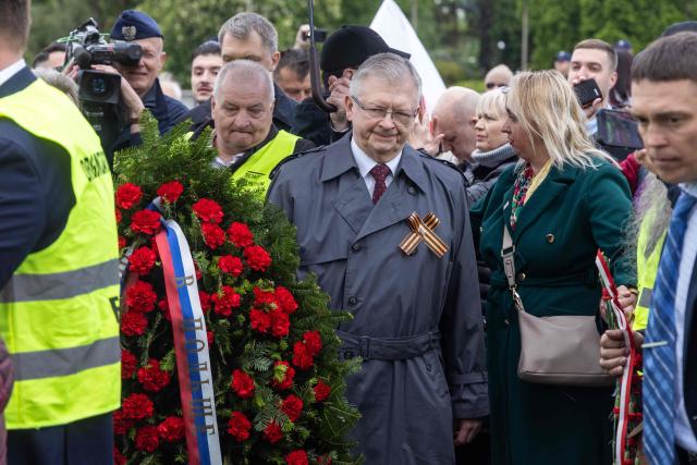 Russia's Ambassador to Poland Sergey Andreev (C) lays a wreath at the Soviet soldier mausoleum in Warsaw, Poland on May 9, 2025. (Photo by Wojtek RADWANSKI / AFP)