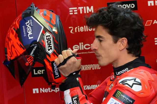 Ducati Lenovo Team's Spanish MotoGP rider Marc Marquez puts on his helmet before the free practice session of the MotoGP France Grand Prix at Le Mans racetrack, western France, on May 9, 2025. (Photo by Loic VENANCE / AFP)