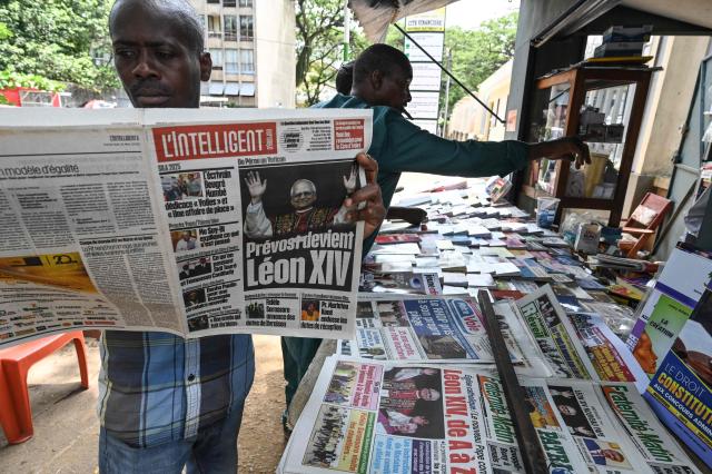 A man reads a daily newspaper, with the front page bearing headlines and images announcing the newly elected Pope Leo XIV, Robert Prevost, in Abidjan on May 9, 2025. Robert Francis Prevost was on May 8, 2025 elected the first pope from the United States, the Vatican announced. A moderate who was close to Pope Francis and spent years as a missionary in Peru, he becomes the Catholic Church's 267th pontiff, taking the papal name Leo XIV. (Photo by Issouf SANOGO / AFP)