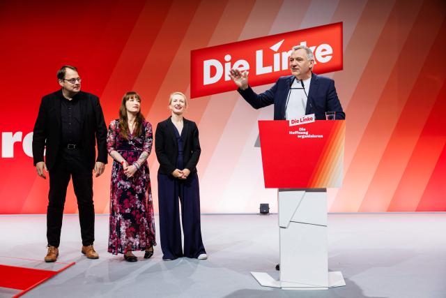 Co-leader of Germany's The Left (Die Linke) party, Jan van Aken (R) addresses delegates next to co-leader Ines Schwerdtner (2nd R) and The Left's parliamentary group leader Heidi Reichinnek (2ndL) and deputy parliamentary group leader Soeren Pellmann (L) as they attend the two-day federal party congress in Chemnitz, eastern Germany on May 9, 2025. (Photo by JENS SCHLUETER / AFP)