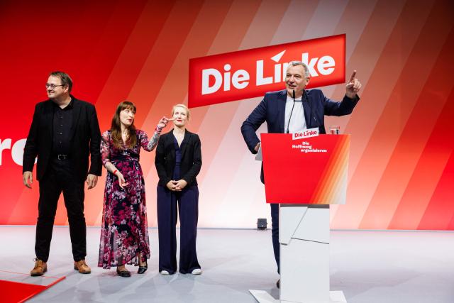 Co-leader of Germany's The Left (Die Linke) party, Jan van Aken (R) addresses delegates next to co-leader Ines Schwerdtner (2nd R) and The Left's parliamentary group leader Heidi Reichinnek (2ndL) and deputy parliamentary group leader Soeren Pellmann (L) during the two-day federal party congress in Chemnitz, eastern Germany on May 9, 2025. (Photo by JENS SCHLUETER / AFP)