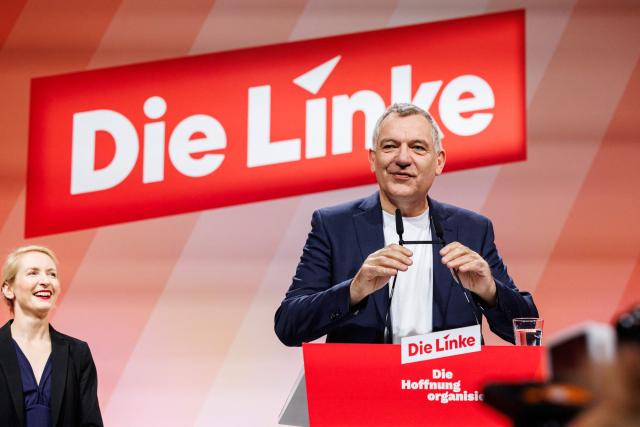 Co-leader of Germany's The Left (Die Linke) party, Ines Schwerdtner (L) reacts as Co-leader of Germany's The Left (Die Linke) party Jan van Aken addresses delegates during the two-day federal party congress in Chemnitz, eastern Germany on May 9, 2025. (Photo by JENS SCHLUETER / AFP)