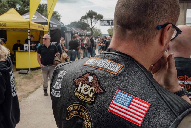 Bikers walk through aisles of stands during the Harley-Davidson Euro 2025 Festival near Grimaud, southern France, on May 9, 2025. (Photo by Frederic DIDES / AFP)