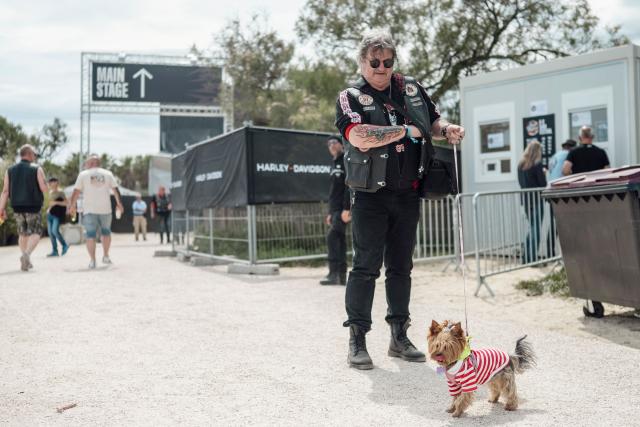 A biker wearing a Harley-Davidson leather jacket poses with his dog during the Harley-Davidson Euro 2025 Festival near Grimaud, southern France, on May 9, 2025. (Photo by Frederic DIDES / AFP)