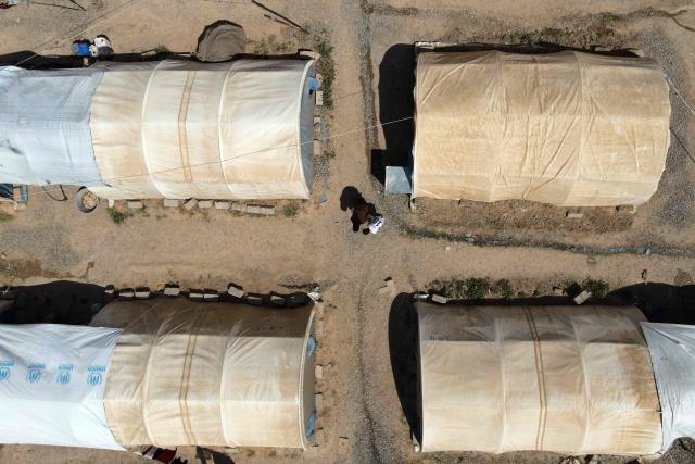 This aerial picture shows tents lined up in the Al-Amal Camp (formerly Al-Jadaa), south of Mosul in northern Iraq, which houses Iraqi families who have been repatriated from Syria's Al-Hol camp, on May 8, 2025. Upon arrival in Iraq, authorities usually keep returnees from Al-Hol, home to tens of thousands of people including family members of suspected jihadists, for weeks or even months at what officials describe as a "psychological rehabilitation" in Al-Jadaa, where they also undergo security checks. (Photo by Zaid AL-OBEIDI / AFP)
