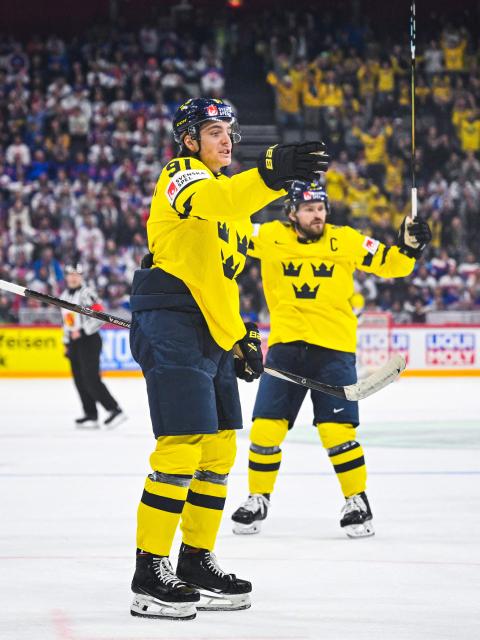 Sweden’s forward #91 Leo Carlsson celebrates with his teammates after scoring 2-0 during the IIHF Men's Ice Hockey World Championship match between Sweden and Slovakia in Stockholm, on May 9, 2025. (Photo by Jonathan NACKSTRAND / AFP)