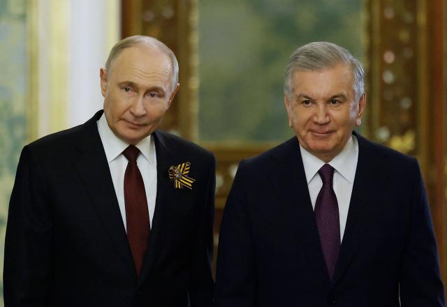 Russian President Vladimir Putin meets with Uzbekistan's President Shavkat Mirziyoyev at the Kremlin in Moscow on May 9, 2025. (Photo by Maxim Shemetov / POOL / AFP)