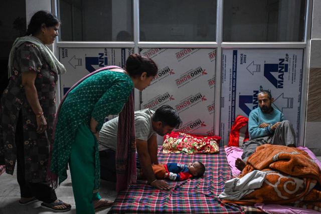 Residents take shelter in the basement of a building during overnight artillery shelling in the main town of Poonch district on May 9, 2025. The Indian army on May 10 reported fresh Pakistani attacks along the border with its arch-foe as the conflict between the nuclear-armed neighbours spiralled. (Photo by Punit PARANJPE / AFP)