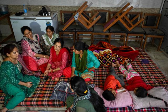 Residents take shelter in the basement of a building during overnight artillery shelling in the main town of Poonch district on May 9, 2025. The Indian army on May 10 reported fresh Pakistani attacks along the border with its arch-foe as the conflict between the nuclear-armed neighbours spiralled. (Photo by Punit PARANJPE / AFP)