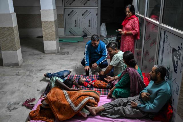 Residents take shelter in the basement of a building during overnight artillery shelling in the main town of Poonch district on May 9, 2025. The Indian army on May 10 reported fresh Pakistani attacks along the border with its arch-foe as the conflict between the nuclear-armed neighbours spiralled. (Photo by Punit PARANJPE / AFP)