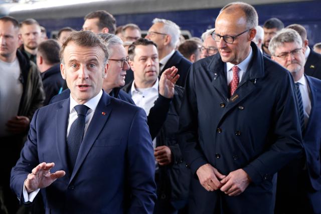 France's President Emmanuel Macron (L), Britain's Prime Minister Keir Starmer (C) and Germany's Chancellor Friedrich Merz arrive at Kyiv railway station on May 10, 2025, ahead of a gathering of European leaders in the Ukranian capital. The leaders of Britain, France, Germany and Poland make an unprecedented joint visit to Kyiv on May 10, 2025 for talks with Ukraine's President Volodymyr and to urge Russia to agree a ceasefire, a joint statement said. (Photo by Ludovic MARIN / POOL / AFP)