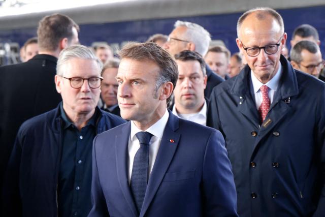 France's President Emmanuel Macron (C), Britain's Prime Minister Keir Starmer (L) and Germany's Chancellor Friedrich Merz arrive at Kyiv railway station on May 10, 2025, ahead of a gathering of European leaders in the Ukranian capital. The leaders of Britain, France, Germany and Poland make an unprecedented joint visit to Kyiv on May 10, 2025 for talks with Ukraine's President Volodymyr and to urge Russia to agree a ceasefire, a joint statement said. (Photo by Ludovic MARIN / POOL / AFP)