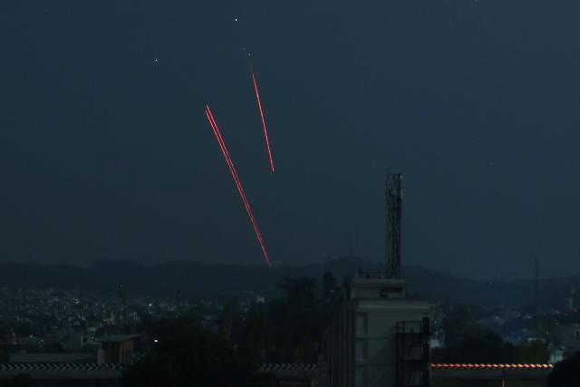 TOPSHOT - Trails from an Indian air defence system are seen above Jammu during a Pakistani strike on May 9, 2025. The Indian army on May 10 reported fresh Pakistani attacks along the border with its arch-foe as the conflict between the nuclear-armed neighbours spiralled. (Photo by Rakesh BAKSHI / AFP)