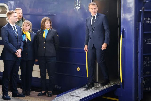 TOPSHOT - France's President Emmanuel Macron steps down from a train as they arrive at Kyiv railway station on May 10, 2025, ahead of a gathering of European leaders in the Ukranian capital. The leaders of Britain, France, Germany and Poland make an unprecedented joint visit to Kyiv on May 10, 2025 for talks with Ukraine's President Volodymyr and to urge Russia to agree a ceasefire, a joint statement said. (Photo by Ludovic MARIN / POOL / AFP)
