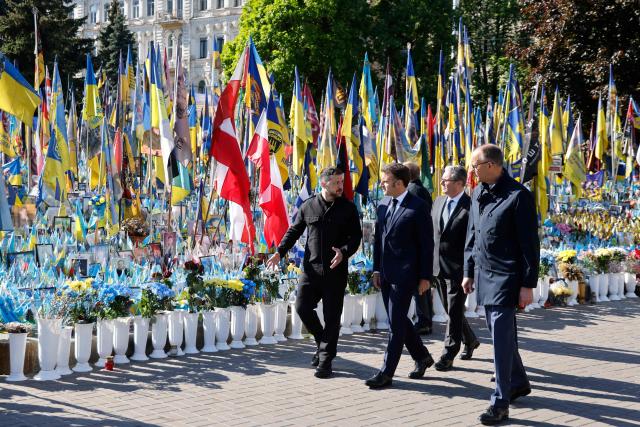 (From L) Ukraine's President Volodymyr Zelensky, France's President Emmanuel Macron, Britain's Prime Minister Keir Starmer and Germany's Chancellor Friedrich Merz pay their respects to the victims of war at the  Memorial for the Fallen at the Independence Square (Maidan) in Kyiv on May 10, 2025, ahead of a gathering of European leaders in the Ukranian capital. The leaders of Britain, France, Germany and Poland make an unprecedented joint visit to Kyiv on May 10, 2025 for talks with Ukraine's President Volodymyr and to urge Russia to agree a ceasefire, a joint statement said. (Photo by Ludovic MARIN / POOL / AFP)