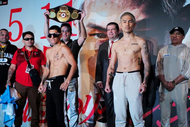 Fernando Martinez of Argentina (front L) and Kazuto Ioka of Japan (front R) pose for a photo session after the weigh-in in Tokyo on May 10, 2025, on the day before the WBA super flyweight title match. (Photo by Kazuhiro NOGI / AFP)