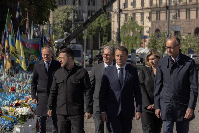 (From L) Poland's Prime Minister Donald Tusk, Ukraine's President Volodymyr Zelensky, Britain's Prime Minister Keir Starmer, France's President Emmanuel Macron, Olena Zelenska and Germany's Chancellor Friedrich Merz pay their respects to the victims of war at the  Memorial for the Fallen at the Independence Square (Maidan) in Kyiv on May 10, 2025, ahead of a gathering of European leaders in the Ukranian capital. The leaders of Britain, France, Germany and Poland make an unprecedented joint visit to Kyiv on May 10, 2025 for talks with Ukraine's President Volodymyr and to urge Russia to agree a ceasefire, a joint statement said. (Photo by Roman PILIPEY / AFP)