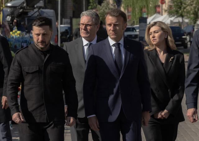 (From L) Ukraine's President Volodymyr Zelensky, Britain's Prime Minister Keir Starmer, France's President Emmanuel Macron and Olena Zelenska pay their respects to the victims of war at the  Memorial for the Fallen at the Independence Square (Maidan) in Kyiv on May 10, 2025, ahead of a gathering of European leaders in the Ukranian capital. The leaders of Britain, France, Germany and Poland make an unprecedented joint visit to Kyiv on May 10, 2025 for talks with Ukraine's President Volodymyr and to urge Russia to agree a ceasefire, a joint statement said. (Photo by Roman PILIPEY / AFP)