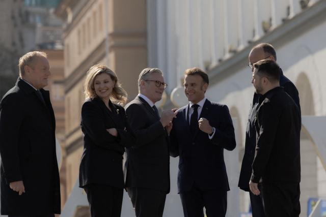 (From L) Poland's Prime Minister Donald Tusk, Olena Zelenska, Britain's Prime Minister Keir Starmer, France's President Emmanuel Macron, Ukraine's President Volodymyr Zelensky  and Germany's Chancellor Friedrich Merz visit the Independence Square (Maidan) in Kyiv on May 10, 2025, ahead of a gathering of European leaders in the Ukranian capital. The leaders of Britain, France, Germany and Poland make an unprecedented joint visit to Kyiv on May 10, 2025 for talks with Ukraine's President Volodymyr and to urge Russia to agree a ceasefire, a joint statement said. (Photo by Roman PILIPEY / AFP)