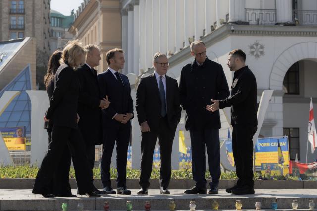 Ukraine's President Volodymyr Zelensky speaks to Poland's Prime Minister Donald Tusk (2nd L), Olena Zelenska (L), France's President Emmanuel Macron (3rd L), Britain's Prime Minister Keir Starmer (3rd R) and Germany's Chancellor Friedrich Merz (2nd R) as they visit the Independence Square (Maidan) in Kyiv on May 10, 2025, ahead of a gathering of European leaders in the Ukranian capital. The leaders of Britain, France, Germany and Poland make an unprecedented joint visit to Kyiv on May 10, 2025 for talks with Ukraine's President Volodymyr and to urge Russia to agree a ceasefire, a joint statement said. (Photo by Roman PILIPEY / AFP)