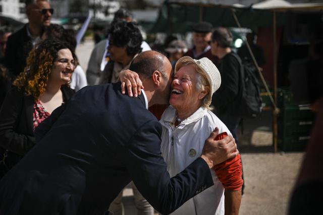 CHEGA far-right party's lawmaker for Algarve, Joao Paulo Graca greets a woman during a party’s electoral campaign action at Quarteira market in Algarve on April 9, 2025. Snap legislative vote take place in Portugal on May 18, the third national election in three years. In Portugal's tourist-friendly south, the far right is gaining ground. Chega (Enough!) came first in the Algarve province in the last poll, with 27.2 percent of the vote. (Photo by PATRICIA DE MELO MOREIRA / AFP)