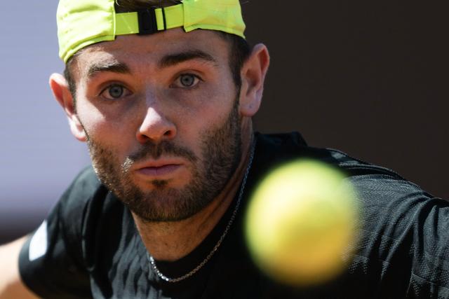 Britain’s Jacob Fearnley eyes the ball as he plays against Italy’s Matteo Berrettini during their men's singles match for the ATP Rome Open tennis tournament at Foro Italico in Rome on May 10, 2025. (Photo by MARCO BERTORELLO / AFP)