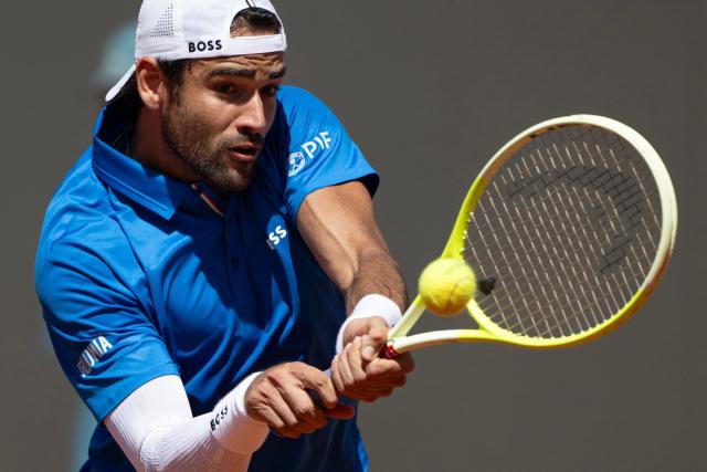 Italy’s Matteo Berrettini plays a backhand return to Britain’s Jacob Fearnley during their men's singles match for the ATP Rome Open tennis tournament at Foro Italico in Rome on May 10, 2025.  (Photo by MARCO BERTORELLO / AFP)