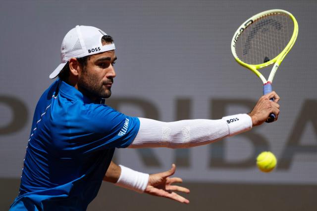 Italy’s Matteo Berrettini plays a backhand return to Britain’s Jacob Fearnley during their men's singles match for the ATP Rome Open tennis tournament at Foro Italico in Rome on May 10, 2025.  (Photo by MARCO BERTORELLO / AFP)