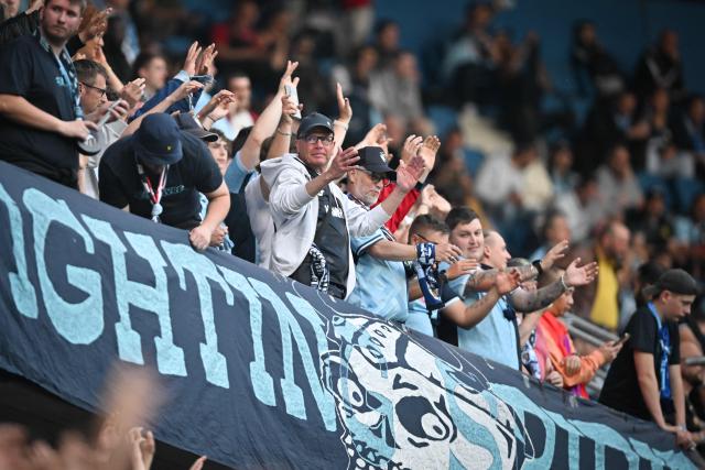 Le Havre's supporters cheer ahead of the French L1 football match between Le Havre AC and Olympique de Marseille (OM) at The Stade Oceane in Le Havre, north-western France, on May 10, 2025. Shortly after the hour mark and opening goal of Marseille, a brawl broke out in a corner adjacent to the Le Havre kop and spectators left the stand to take cover, bringing the match to a halt in the 64th minute and prompting referee Willy Delajod to send the players back to the dressing room. (Photo by Lou BENOIST / AFP)