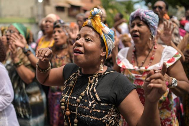 A woman wearing a typical dress dances during the celebration of Afro-Venezuelan Day in Caucagua, Miranda state, Venezuela on May 10, 2025. Afro-Venezuelan Day is celebrated in Venezuela on May 10, commemorating the heritage and cultural contributions of the Venezuelan Afro-descendant community, as well as their struggle and resistance against slavery. (Photo by Juan BARRETO / AFP)