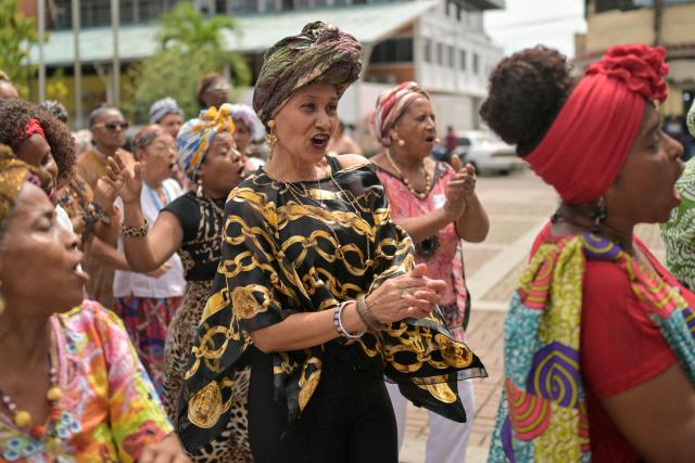 Women wearing typical dresses dance during the celebration of Afro-Venezuelan Day in Caucagua, Miranda state, Venezuela on May 10, 2025. Afro-Venezuelan Day is celebrated in Venezuela on May 10, commemorating the heritage and cultural contributions of the Venezuelan Afro-descendant community, as well as their struggle and resistance against slavery. (Photo by Juan BARRETO / AFP)