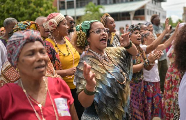 Women wearing typical dresses dance during the celebration of Afro-Venezuelan Day in Caucagua, Miranda state, Venezuela on May 10, 2025. Afro-Venezuelan Day is celebrated in Venezuela on May 10, commemorating the heritage and cultural contributions of the Venezuelan Afro-descendant community, as well as their struggle and resistance against slavery. (Photo by Juan BARRETO / AFP)