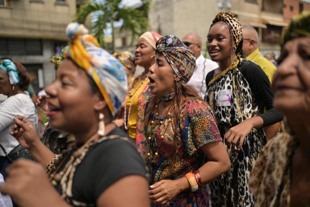Women wearing typical dresses dance during the celebration of Afro-Venezuelan Day in Caucagua, Miranda state, Venezuela on May 10, 2025. Afro-Venezuelan Day is celebrated in Venezuela on May 10, commemorating the heritage and cultural contributions of the Venezuelan Afro-descendant community, as well as their struggle and resistance against slavery. (Photo by Juan BARRETO / AFP)