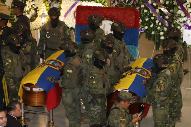 Soldiers guard the coffins with the mortal remains of the 11 soldiers killed on the eve, during their wake at the Eloy Alfaro Military College in Quito on May 10, 2025. Ecuador declared three days of national mourning over the deaths of 11 soldiers who the army said were killed by dissident FARC guerrillas in an ambush in Alto Punino, near the Colombian border. The attack comes amid a spike in violence in both nations linked to the trafficking of cocaine produced in Colombia and exported through Ecuadorean ports to the United States and Europe. (Photo by ARMANDO PRADO / AFP)