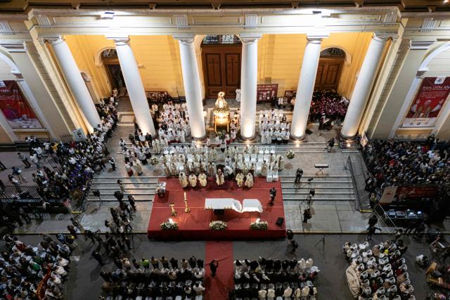 Bishop of Chiclayo Edinson Edgardo Farfán (C) leads a mass in honour of newly elected Pope Leo XIV at the Cathedral of Saint Mary in Chiclayo, Peru on May 10, 2025. US' Robert Francis Prevost, who became a Peruvian national in 2015, was elected pope on May 8, 2025, picking the papal name Leo XIV. The US-born pontiff was bishop of Chiclayo from 2015 to 2023, when he was made a cardinal and moved to Rome. (Photo by Ernesto BENAVIDES / AFP)